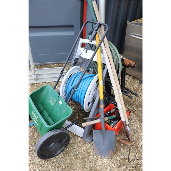 Selection of gardening tools and accessories including Scotts seed and fertilizer spreader, hose ree