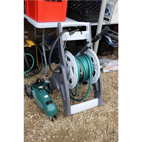Orbit self propelled sprinkler, hose reel with hose, small stationary sprinkler, and scrub brush