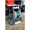 Image 1 : Orbit self propelled sprinkler, hose reel with hose, small stationary sprinkler, and scrub brush