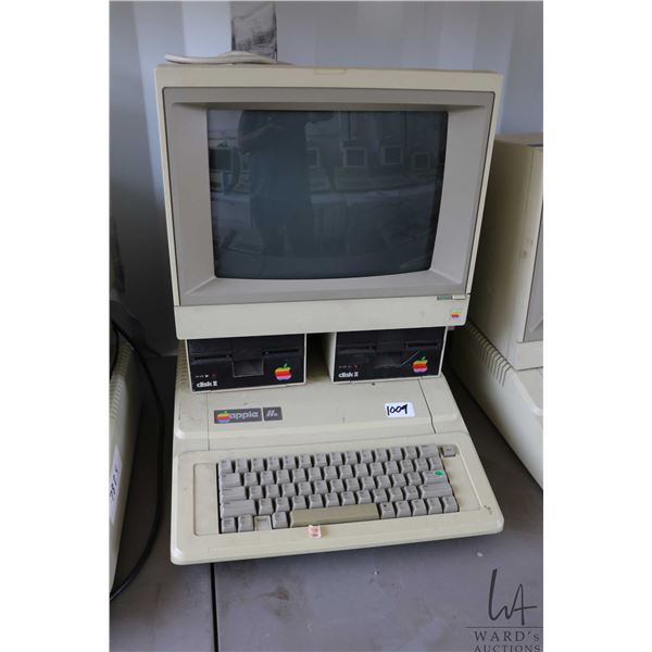 Vintage 1980s Apple IIE with two Apple Disk II disk drives and Apple Apple ColorMonitor IIe. See pho