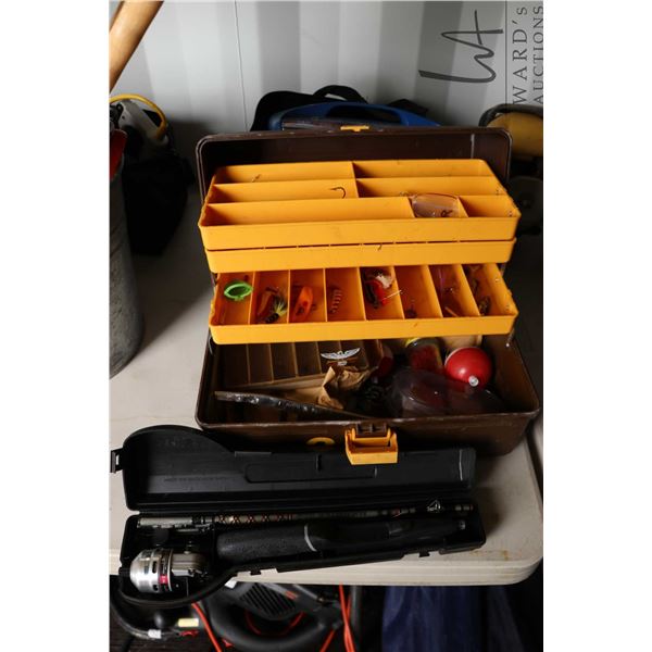 Daiwa mini cast system fishing rod and a tackle box with assorted lures and fishing accessories