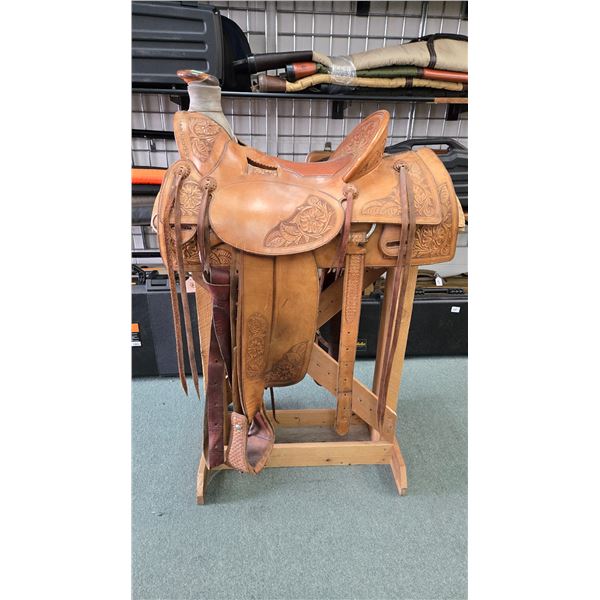 Quality western leather saddle by maker Matt Eberle of Highriver Alberta with floral design and high