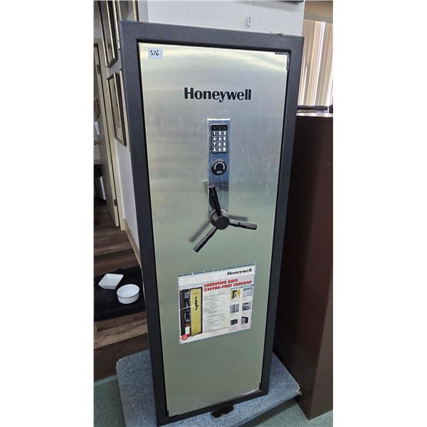 Honeywell executive digital safe measuring 59" H x 21" W x 16" D. Comes w/ 3 shelves, 14 gun holder,