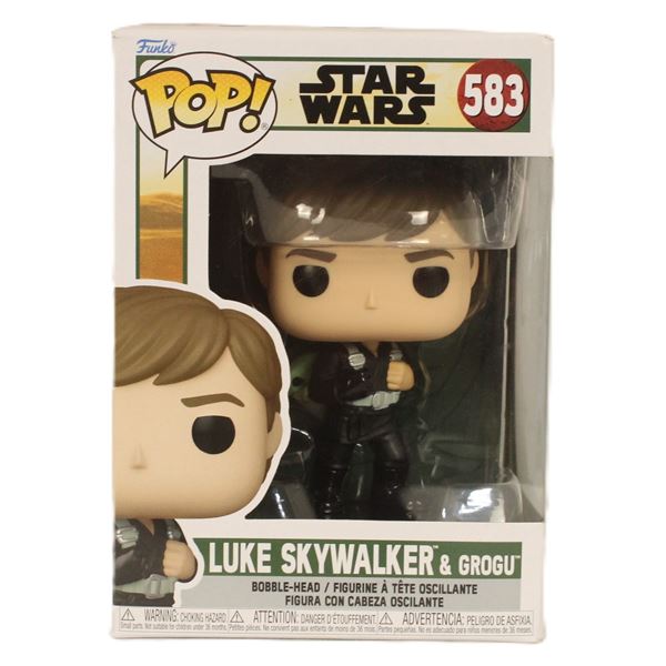 A Luke Skywalker and Grogu #583 Funko Pop.