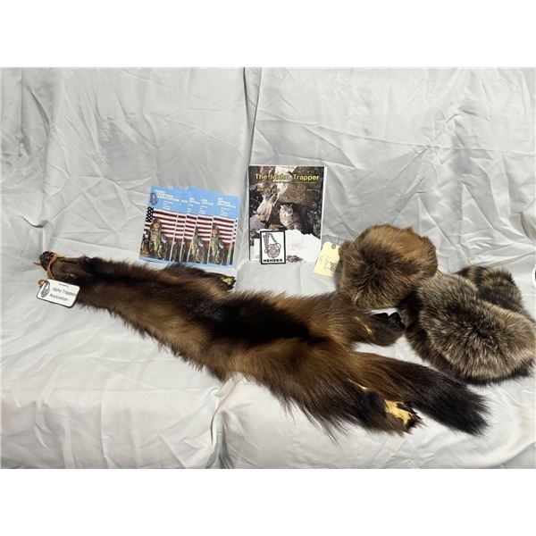 Genuine wolverine hide complimented with a coon skin and beaver skin hat.