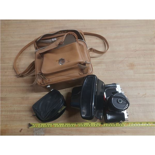Vintage film camera kit, including a camera body with a lens attached.