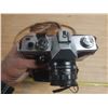 Image 3 : Vintage film camera kit, including a camera body with a lens attached.