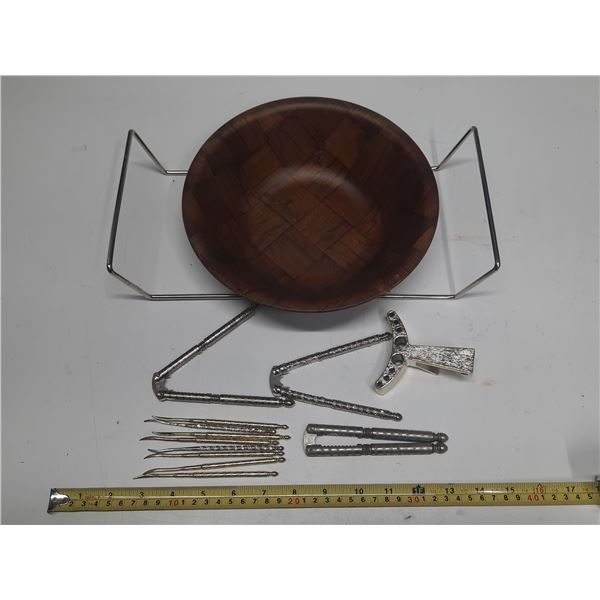 Vintage walnut wood salad bowl set with a metal wire stand, accompanying nutcrackers, and serving pi