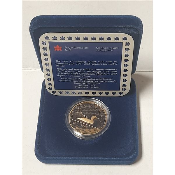 1987 Proof Loonie Dollar. Ultra Heavy Cameo. The first year of the Loonie. Housed in its original Ro