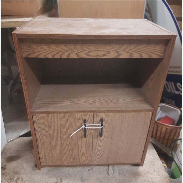 This item is likely an oak-finished microwave cart or small entertainment stand with wheels on botto