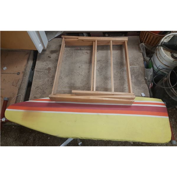 Vintage folding ironing board with a striped cover (Height 35"), positioned in front of a wooden dry