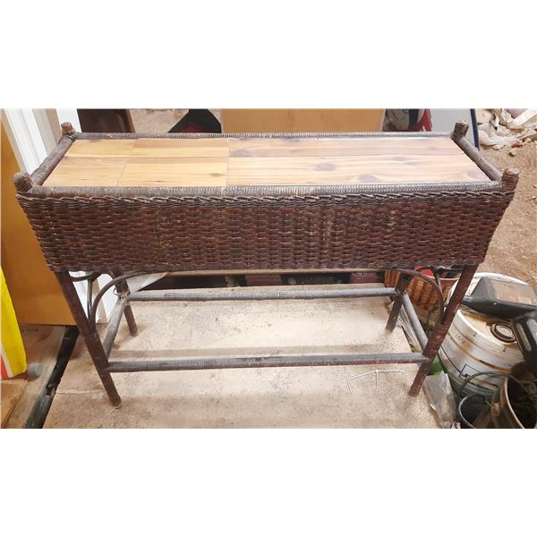 Vintage wicker planter box likely features a metal liner and is constructed in a style popular durin