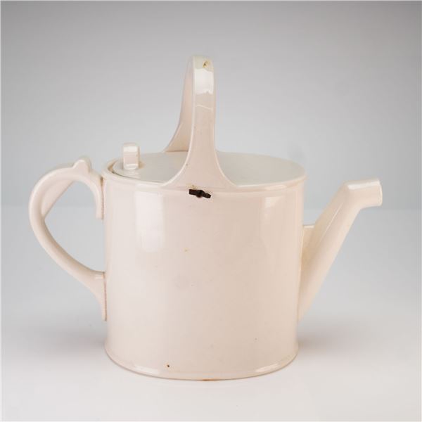 A Cream-Colored Porcelain Watering Can Form Teapot