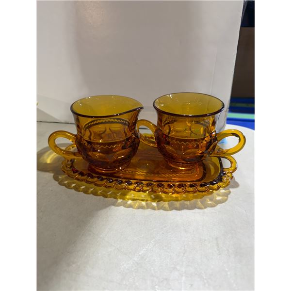 Indiana Glass Company creamer, sugar bowl, and tray set in the amber "Kings Crown" thumbprint patter