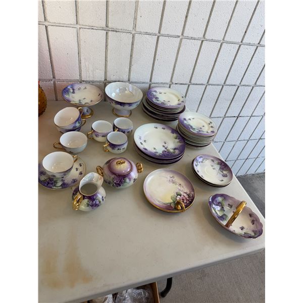 an antique collection of hand-painted porcelain from Limoges, France, featuring a violet floral patt