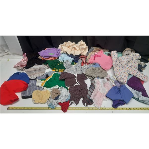 Lot of Doll Clothes of Different Sizes.