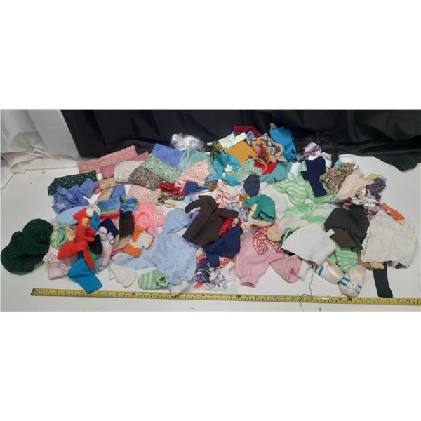 Lot of Doll Clothes of Different Sizes.