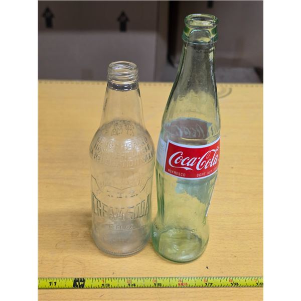 2 glass bottles- Coca Cola and BC cream soda