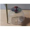 Image 1 : Vintage tilted glass penny candy jar with a chrome lid and a red knob.