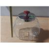 Image 2 : Vintage tilted glass penny candy jar with a chrome lid and a red knob.