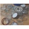 Image 2 : Vintage canning jar components, including glass lids, rubber rings, and a patterned plastic containe