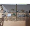 Image 4 : Collection of vintage glass canning jars, commonly known as Mason jars, housed within a black plasti