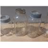 Image 6 : Collection of vintage glass canning jars, commonly known as Mason jars, housed within a black plasti