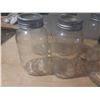 Image 4 : Collection of vintage glass canning jars, commonly known as Mason jars, housed within a black plasti