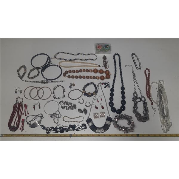 Vintage costume jewelry, including a variety of bracelets, earrings, and necklaces.