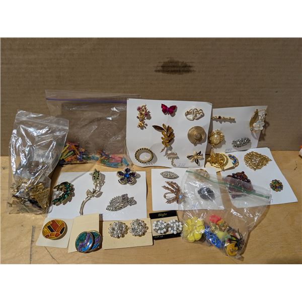 Bag full of Misc. Costume jewelry (Brooches) and etc. As Shown