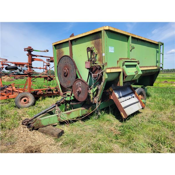 Green feed wagon, 12 ft, condition unknown, no visible serial #. Located at 23012 Twp 604, North Wes