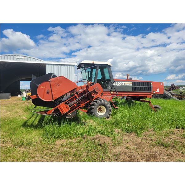 Hesston 8200 Swather. 21.5L-16.1 front rubber, 7.60-15SL rear tires, diesel engine. Showing 2116hrs,