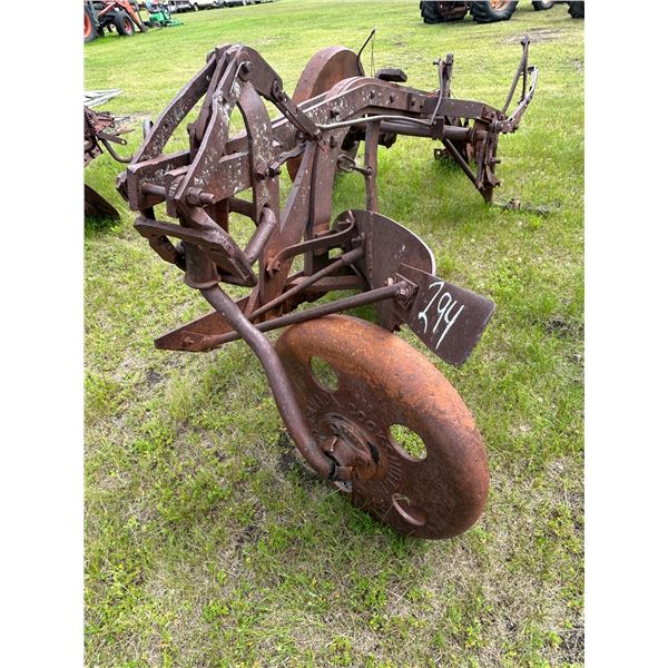 Single bottom breaking plow, missing one wheel