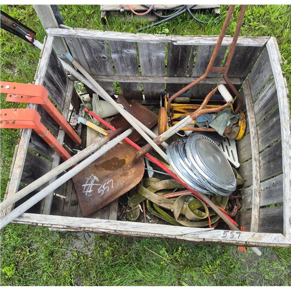 Crate full of hand tools, hub caps, old push mower, and misc.