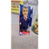 Image 2 : Bill Clinton Talking Doll, Lincoln Logs Frontier Explorer Set, Parrot Clock, Giant PEZ Dispenser