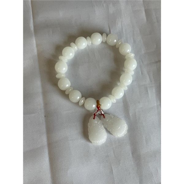 WHITE JADE BEAD BRACELET W/ PAIR OF CARVED TASSELS