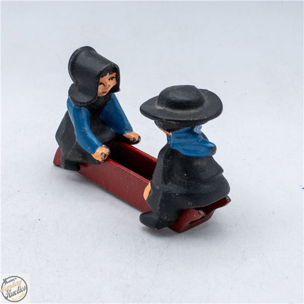 ANTIQUE CAST IRON AMISH FIGURINES ON SLED