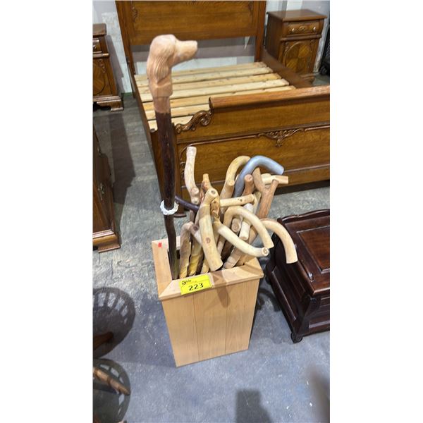 WOOD UMBRELLA STAND WITH A COLLECTION OF WOOD CANES