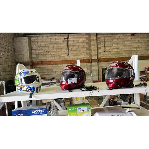 SHELF OF ASSORTED MOTORCYCLE HELMETS (SOME WITH BUILT IN COMMUNICATION DEVICES)