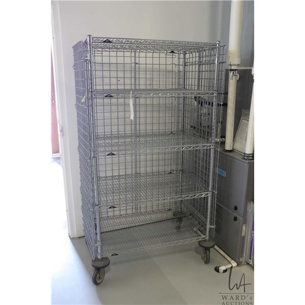 Heavy duty two door, lockable cabinet on castors, three shelves, 68"h x 38"w x 24"d.