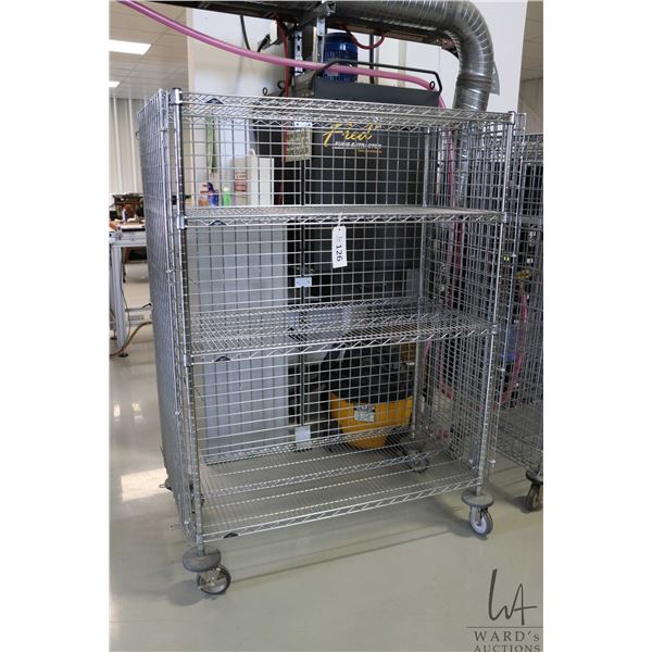 Heavy duty two door, lockable cabinet on castors, two shelves, 68"h x 49"w x 25"d.