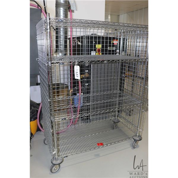 Heavy duty two door, lockable cabinet on castors, two shelves, 68"h x 49"w x 25"d.