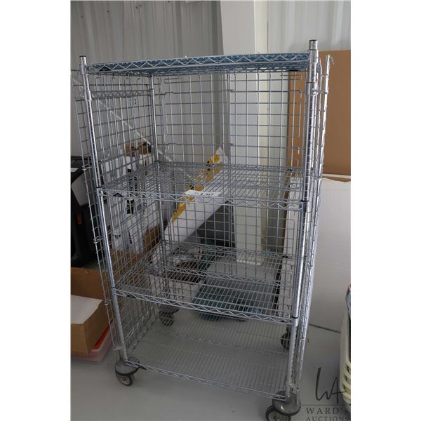 Heavy duty two door, lockable cabinet on castors, two shelves, 68"h x 38"w x 25"d.