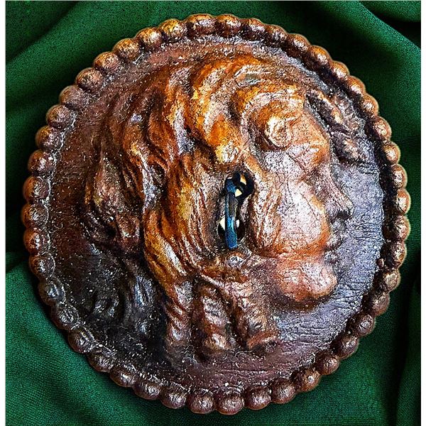 A DIVISION THREE CARVED WOOD PROFILE BUTTON
