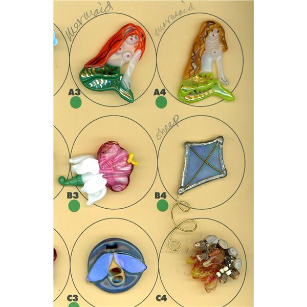 A PARTIAL CARD OF DIVISION THREE GLASS BUTTONS