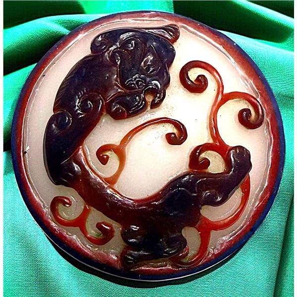 A DIVISION THREE CARVED GLASS BUTTON