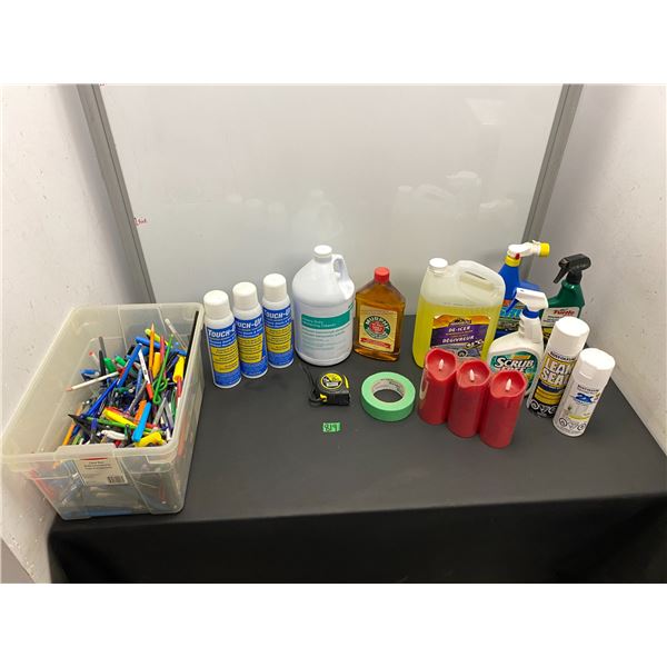 Lot of household cleaning supplies and pens, flameless candles, measuring tape