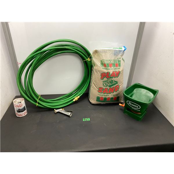 Yard items including lawn hose, play sand