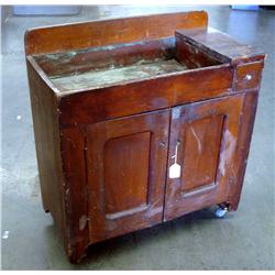 Antique Copper sink in dark wood cabinet