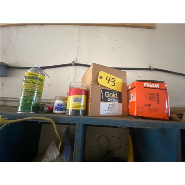 Assorted filters, oils, engine repair kit, silicone guns, elect. Tape. Contents of items in shelf.